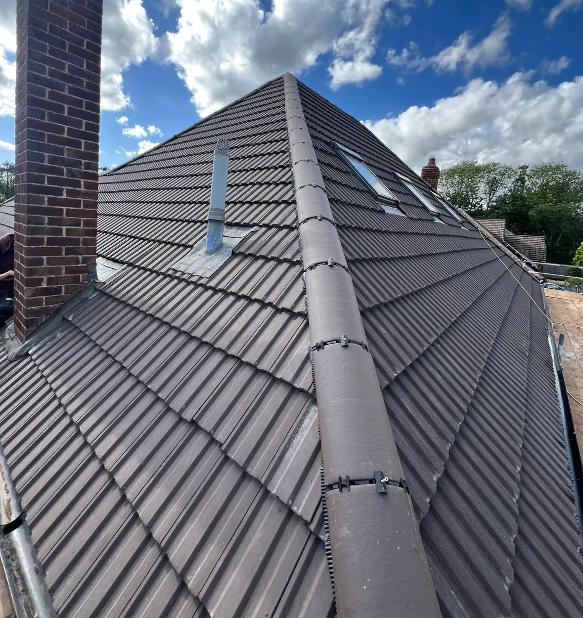Pitched roof ridge tile replacement in progress